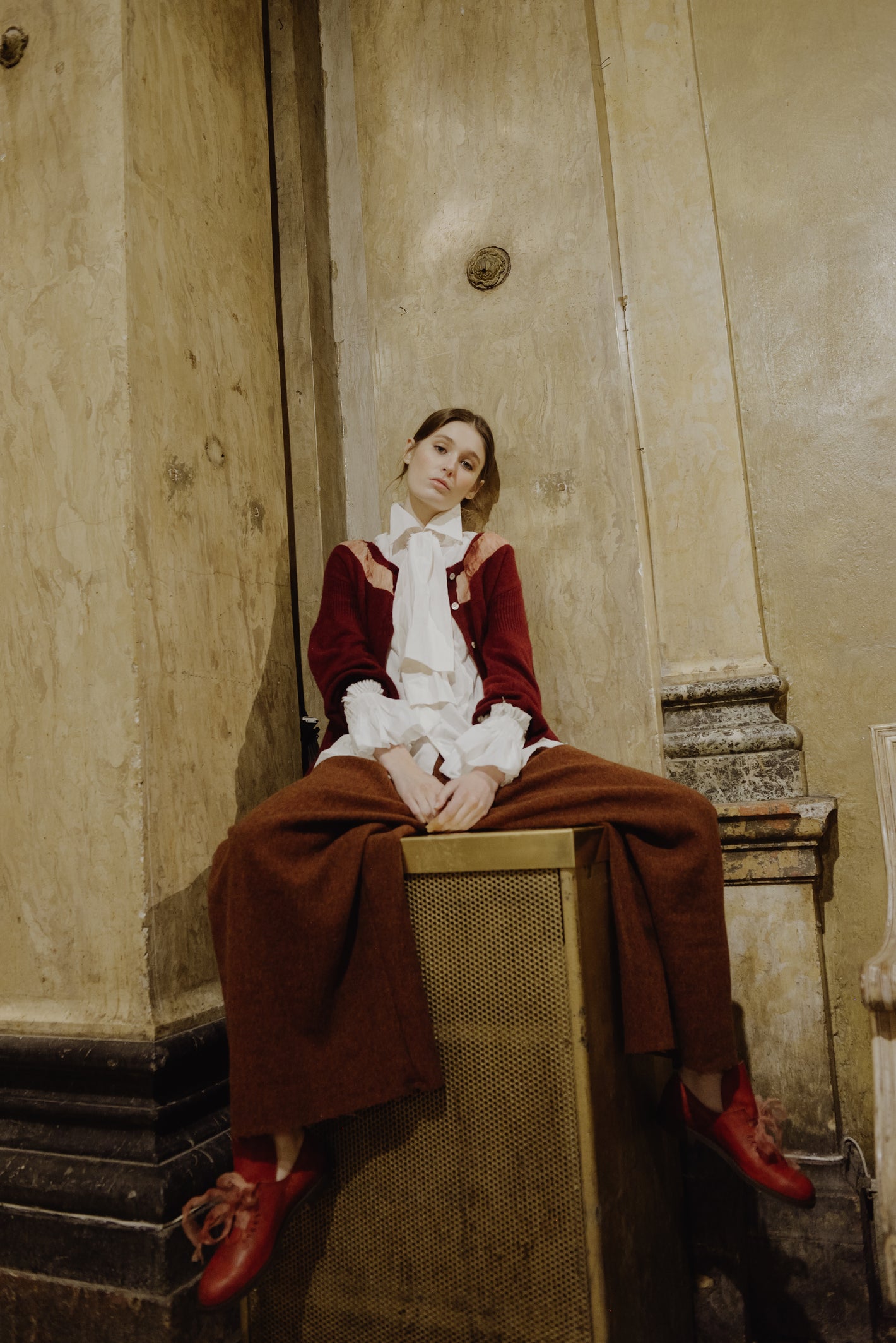 A Tentative Atelier AW19 Lookbook Womens white pussy-bow shirt, red cardigan and brown wool wide leg trousers