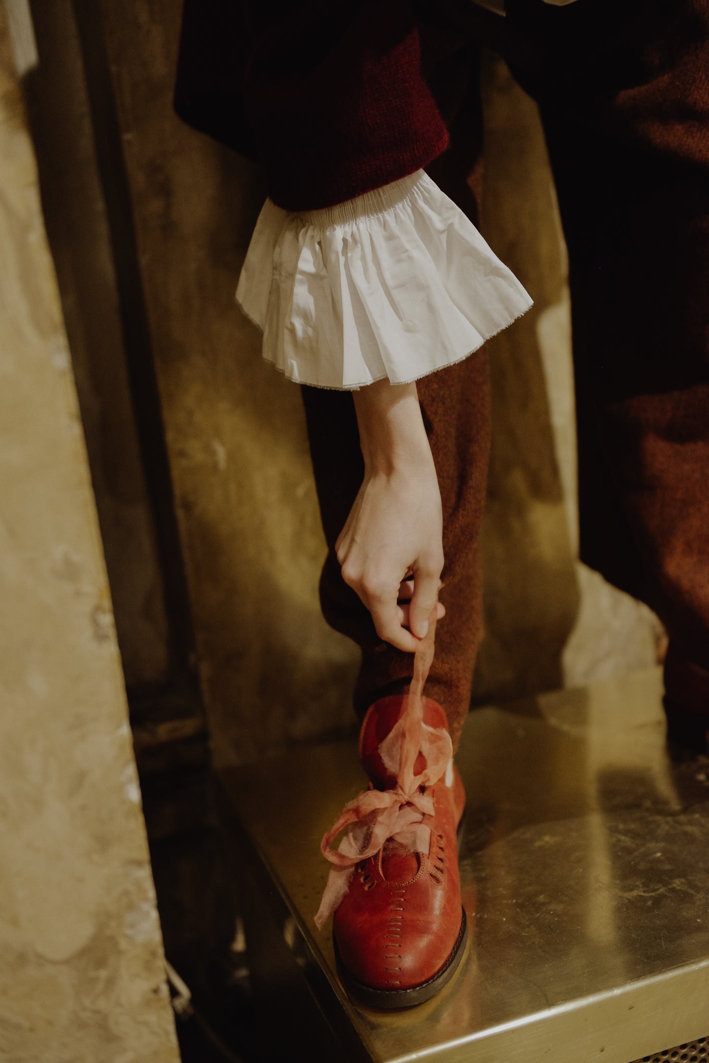 A Tentative Atelier AW19 Lookbook Womens crop of a red leather shoe with ribbon laces