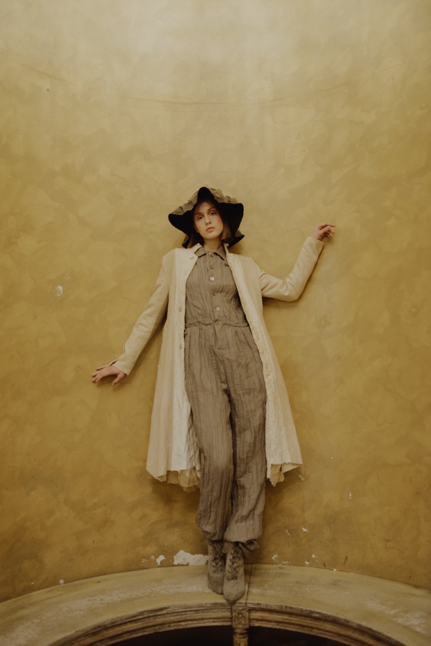 A Tentative Atelier AW19 Lookbook Womens brown striped jumpsuit, cream coat and floppy brown hat