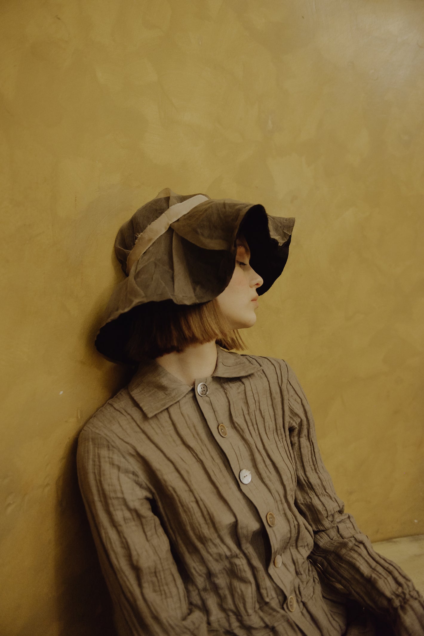 A Tentative Atelier AW19 Lookbook Womens crop of crinkle button-up brown jumpsuit and brown floppy hat