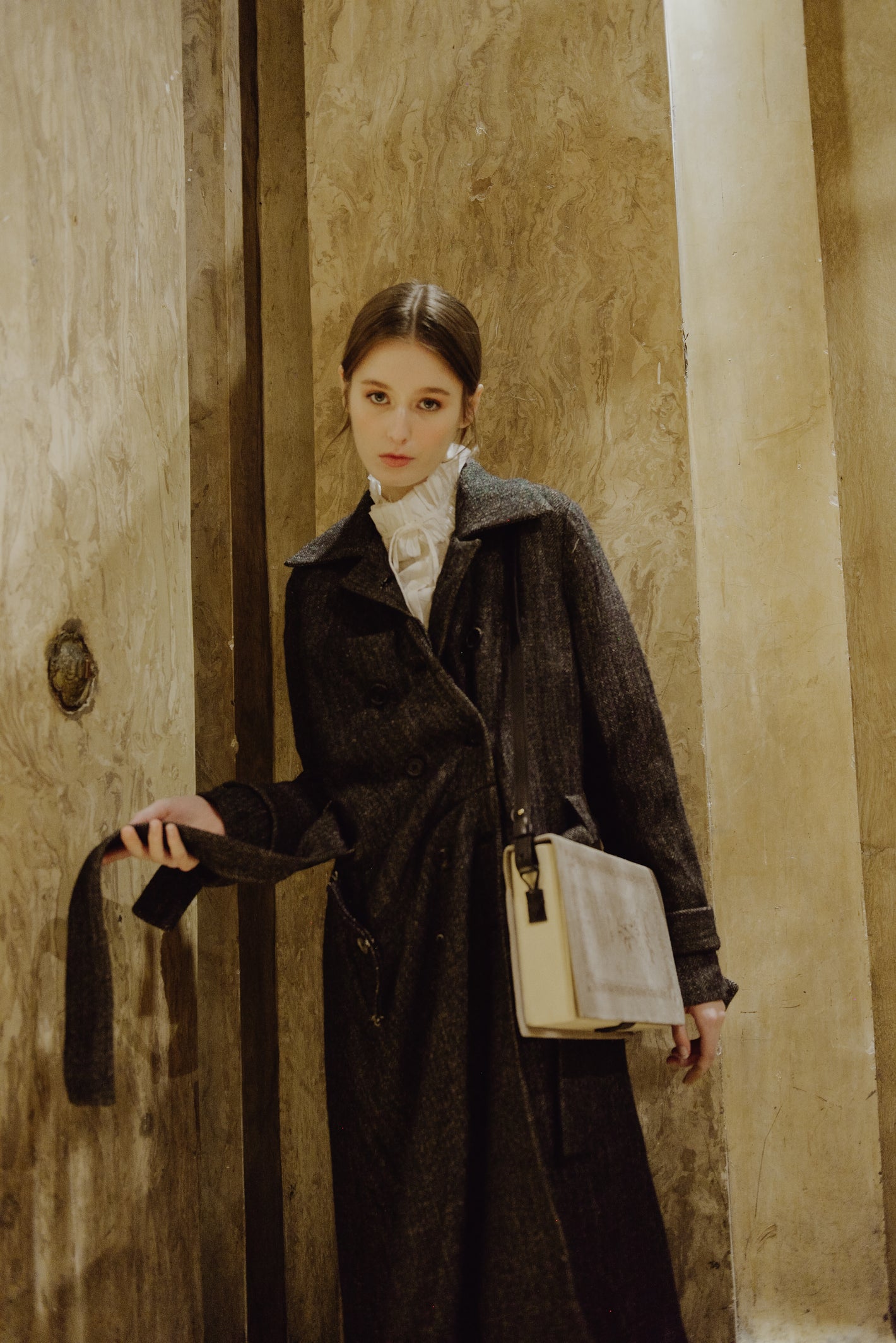 A Tentative Atelier AW19 Lookbook Womens crop of a charcoal coat and "book" shoulder bag