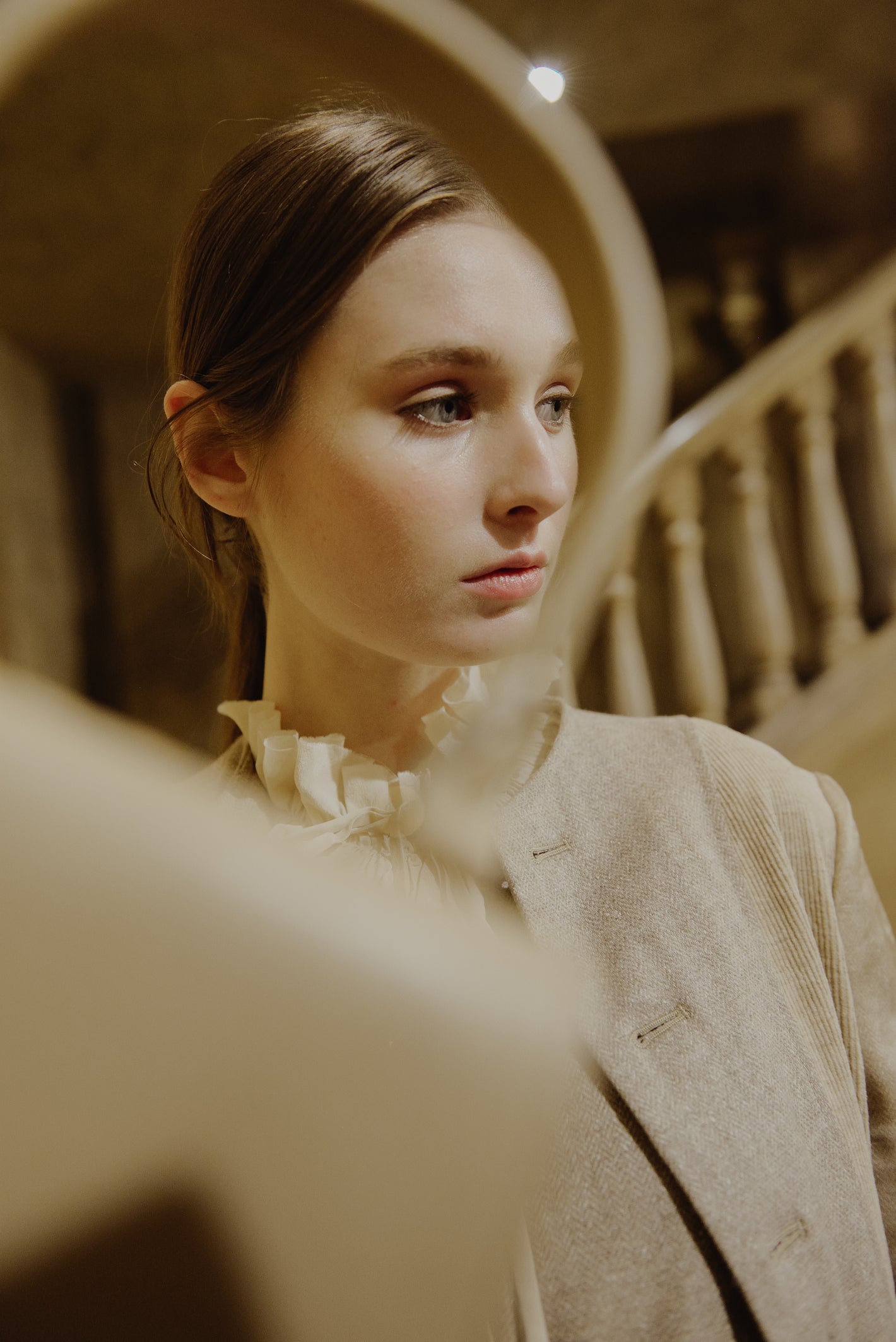 A Tentative Atelier AW19 Lookbook Womens crop of a model with blurred bag handle in the foreground