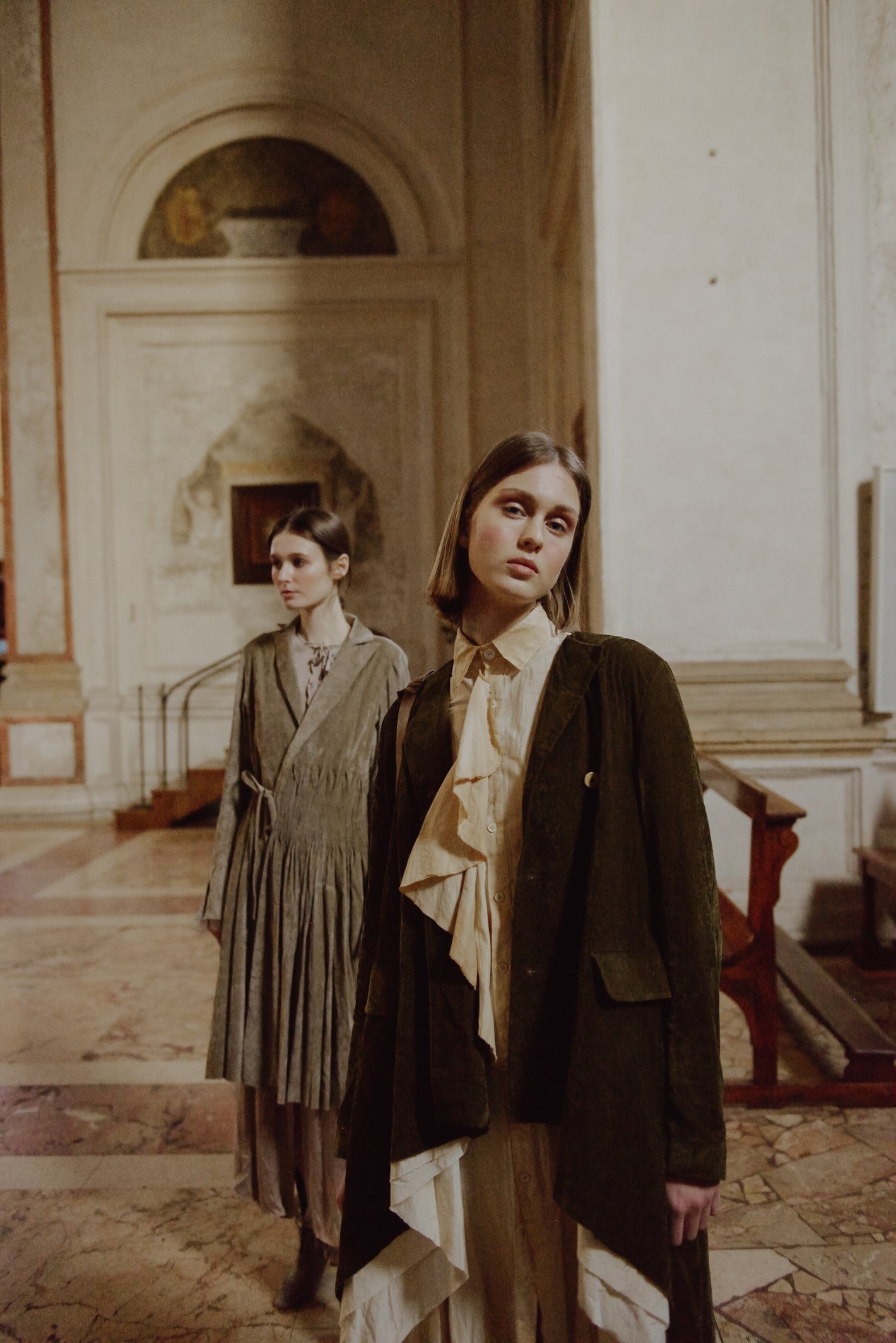 A Tentative Atelier AW19 Lookbook Womens crop of two models, pictured wearing a brown smocked waist coat and moss green brown jacket respectively 2