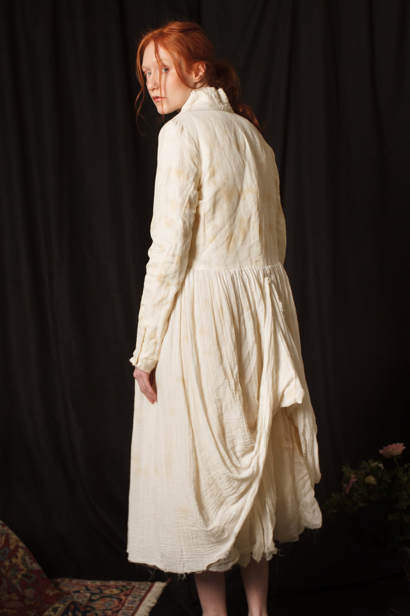 A Tentative Atelier AW18 Lookbook Womens crop of the back of a white stained coat showing a draped back