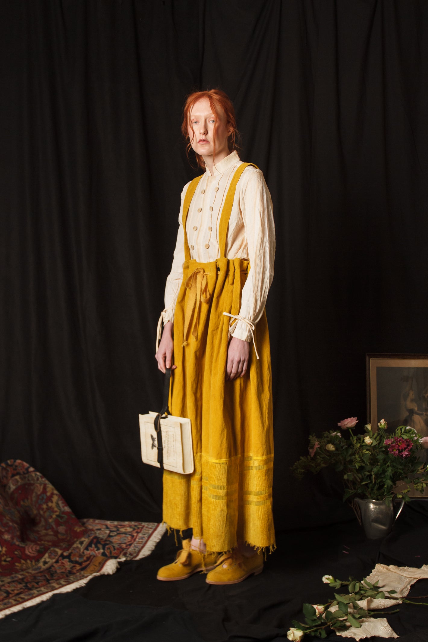 A Tentative Atelier AW18 Lookbook Womens mustard yellow velvet suspenders skirt and "Book" bag