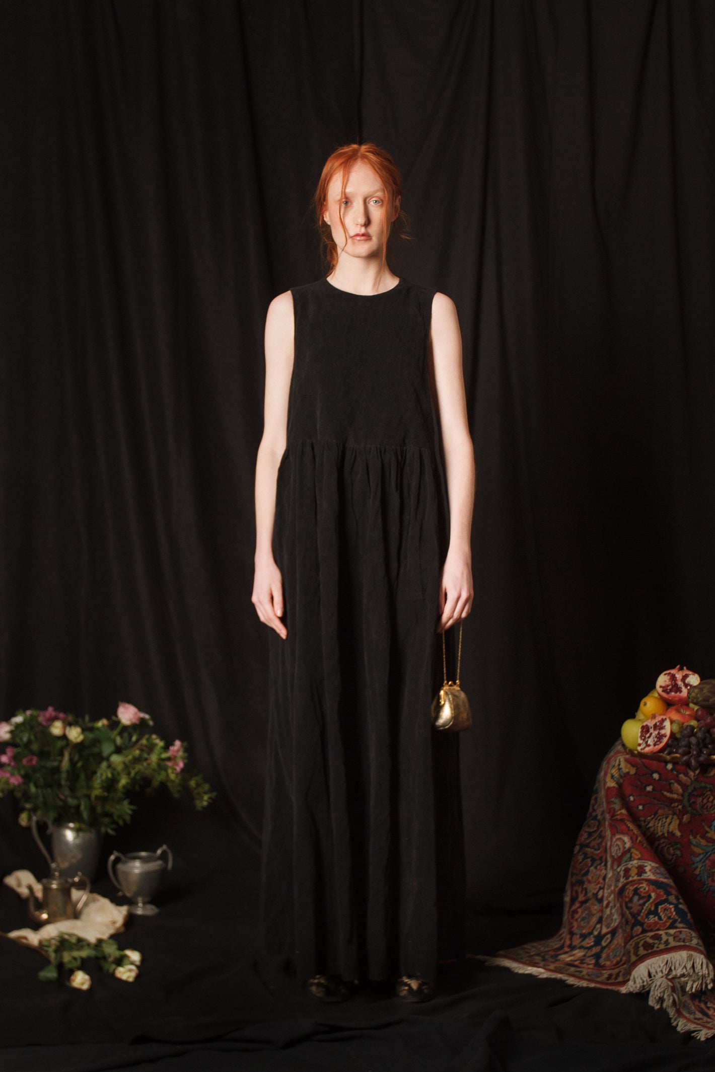 A Tentative Atelier AW18 Lookbook Womens black sleeveless dress and mini gold chain bag