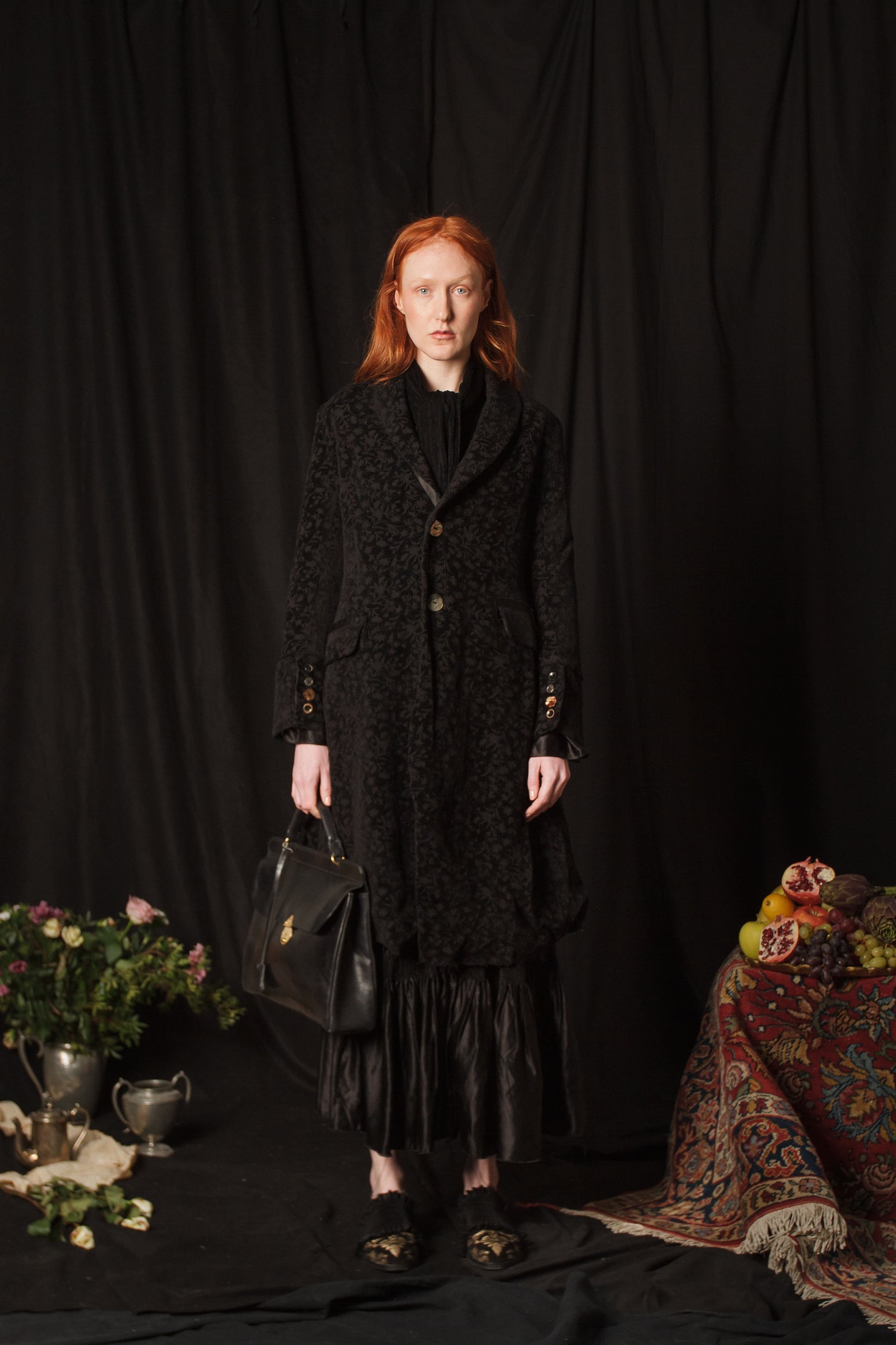 A Tentative Atelier AW18 Lookbook Womens black velvet embroidered coat and black leather top handle bag