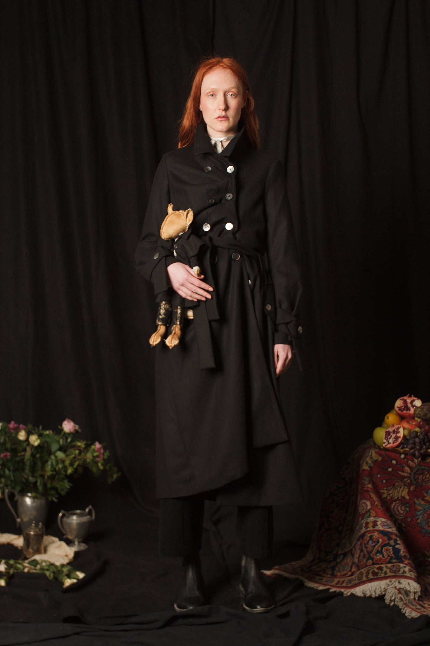 A Tentative Atelier AW18 Lookbook Womens black trench coat and matching toy plushie