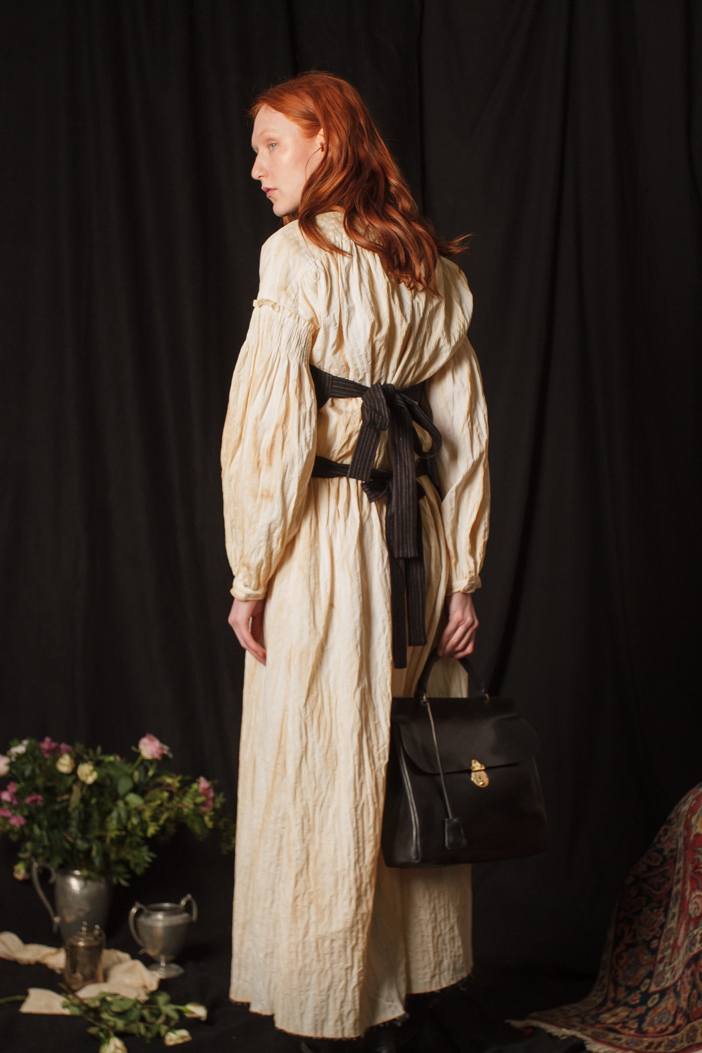 A Tentative Atelier AW18 Lookbook Womens crop of back ties fastening waistcoat and black leather top handle bag