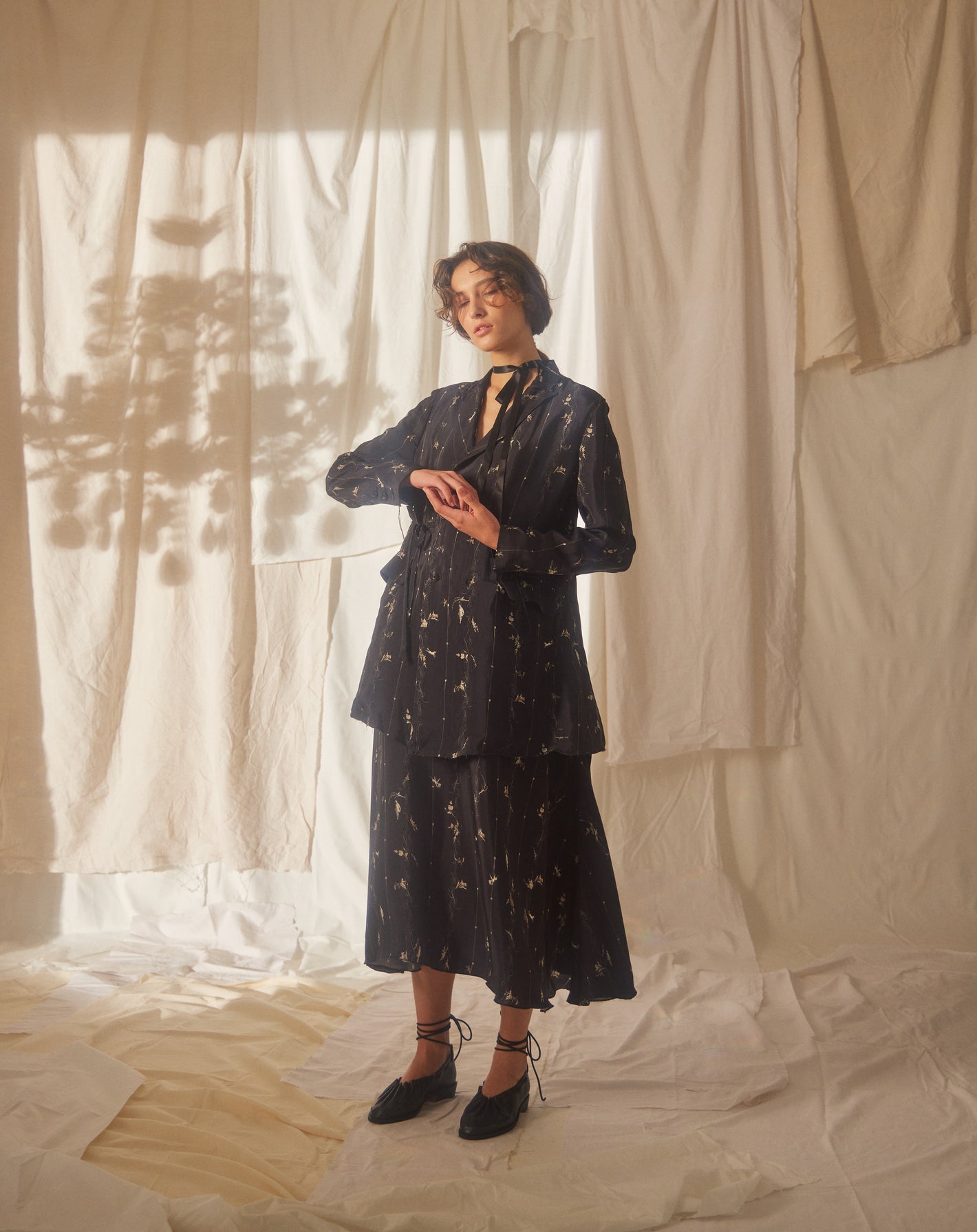 A Tentative Atelier SS22 Lookbook black patterned jacket and skirt