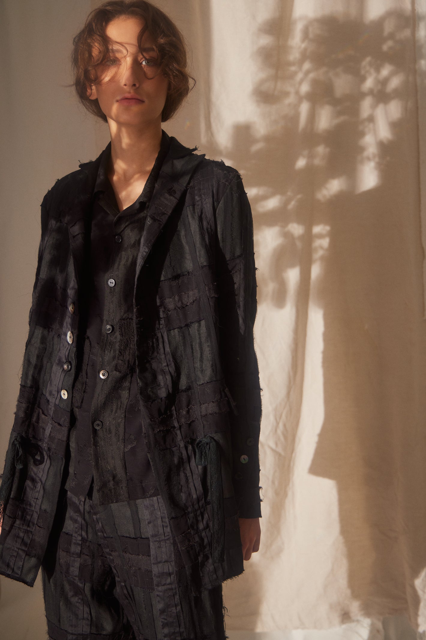 A Tentative Atelier SS22 Lookbook crop of black patchwork jacket