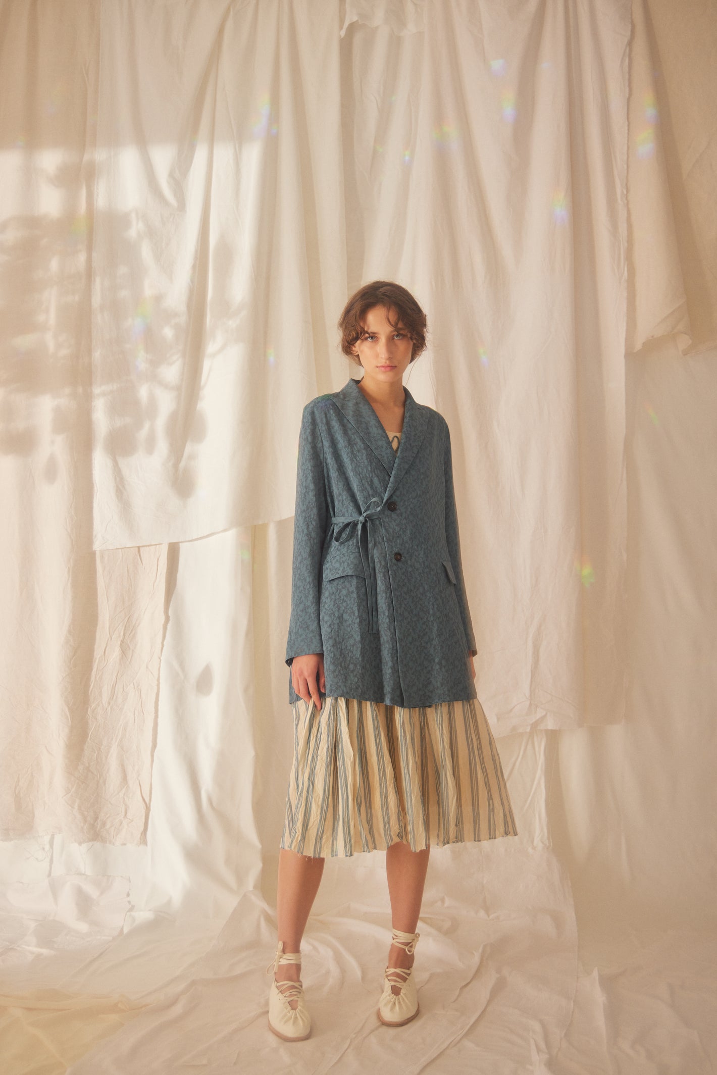A Tentative Atelier SS22 Lookbook blue side fastening jacket and striped skirt ensemble