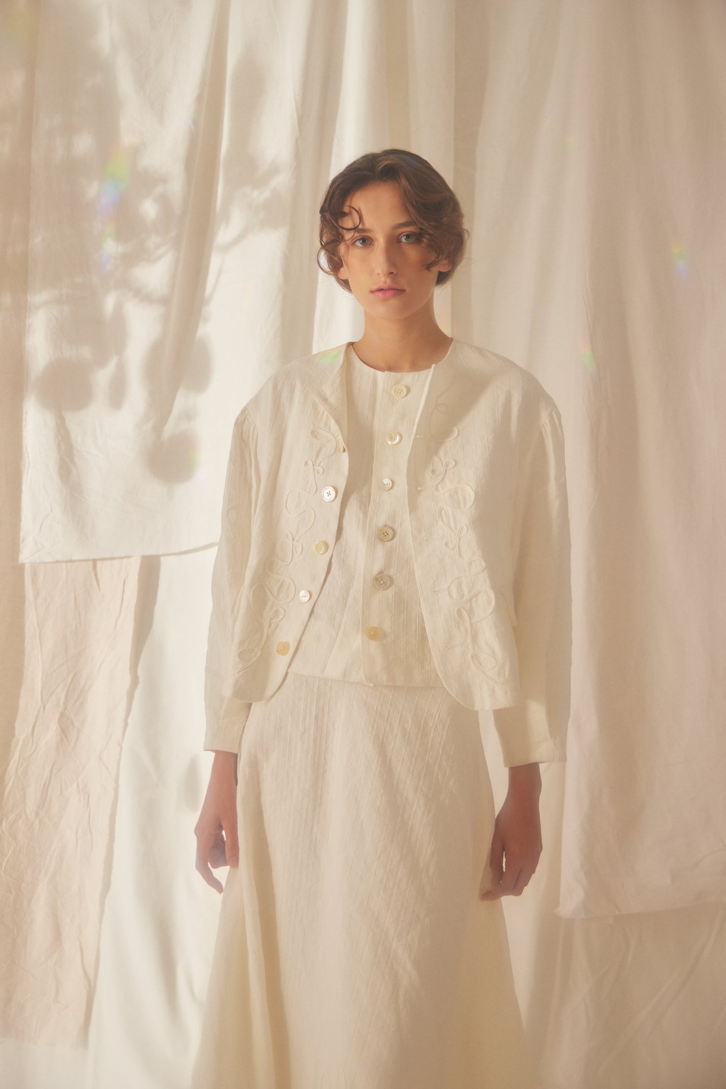 A Tentative Atelier SS22 Lookbook crop of a boxy white embroidered cropped jacket