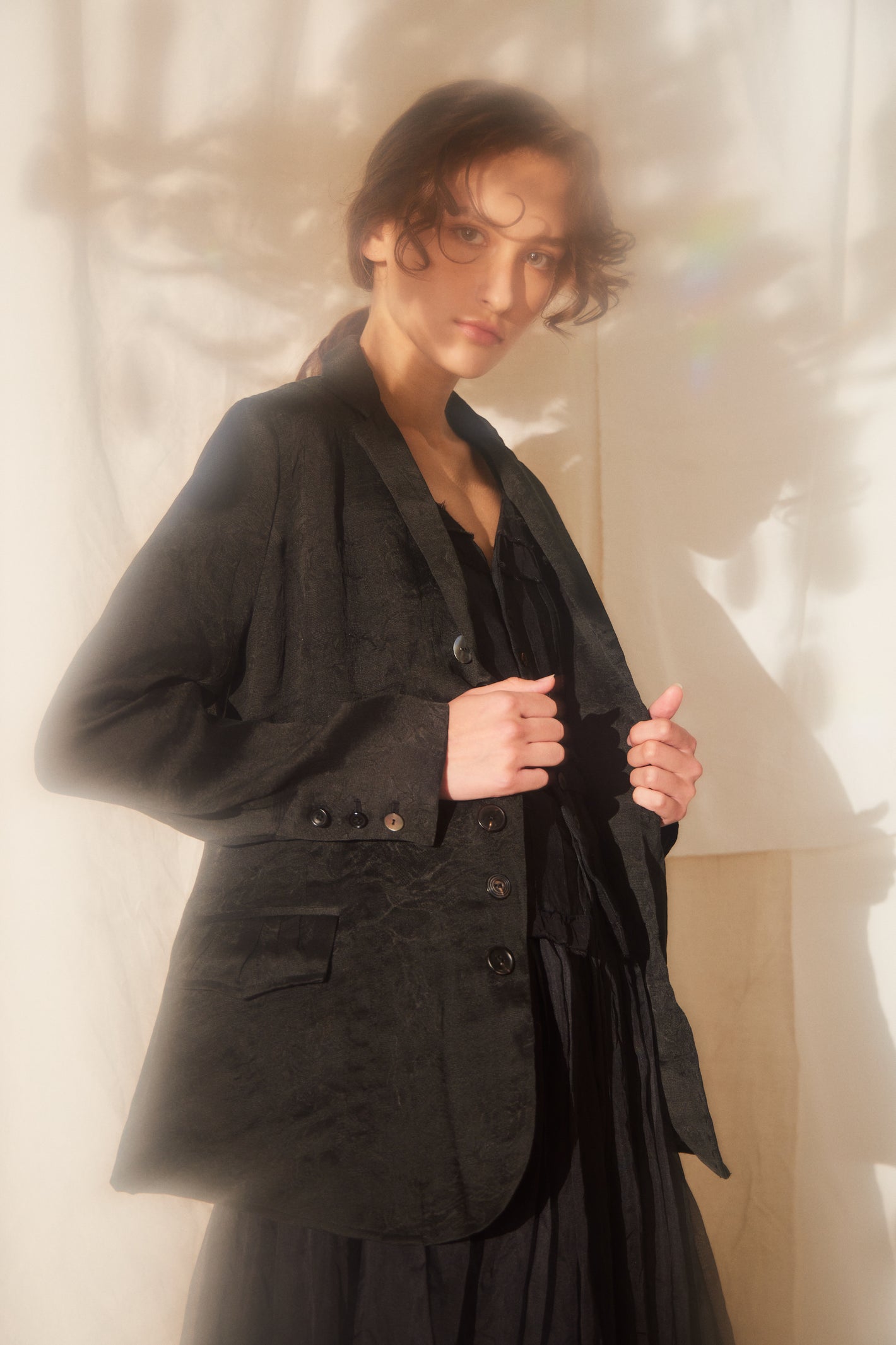 A Tentative Atelier SS22 Lookbook crop of black silk jacket