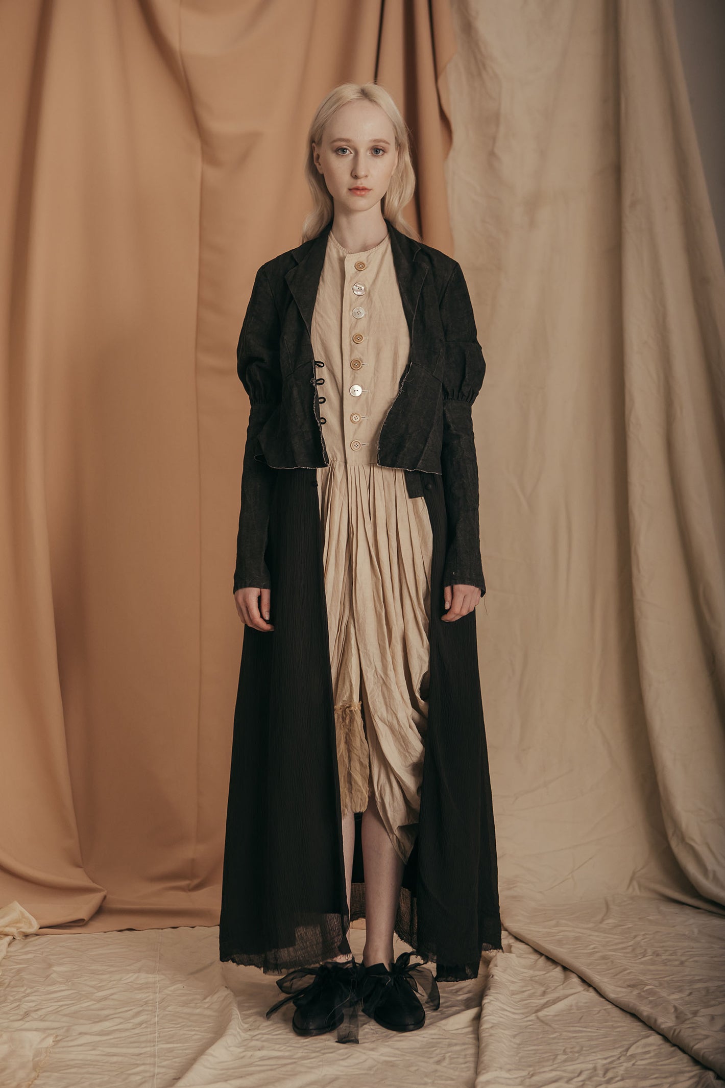 A Tentative Atelier SS20 Lookbook Womens long black coat and beige draped dress
