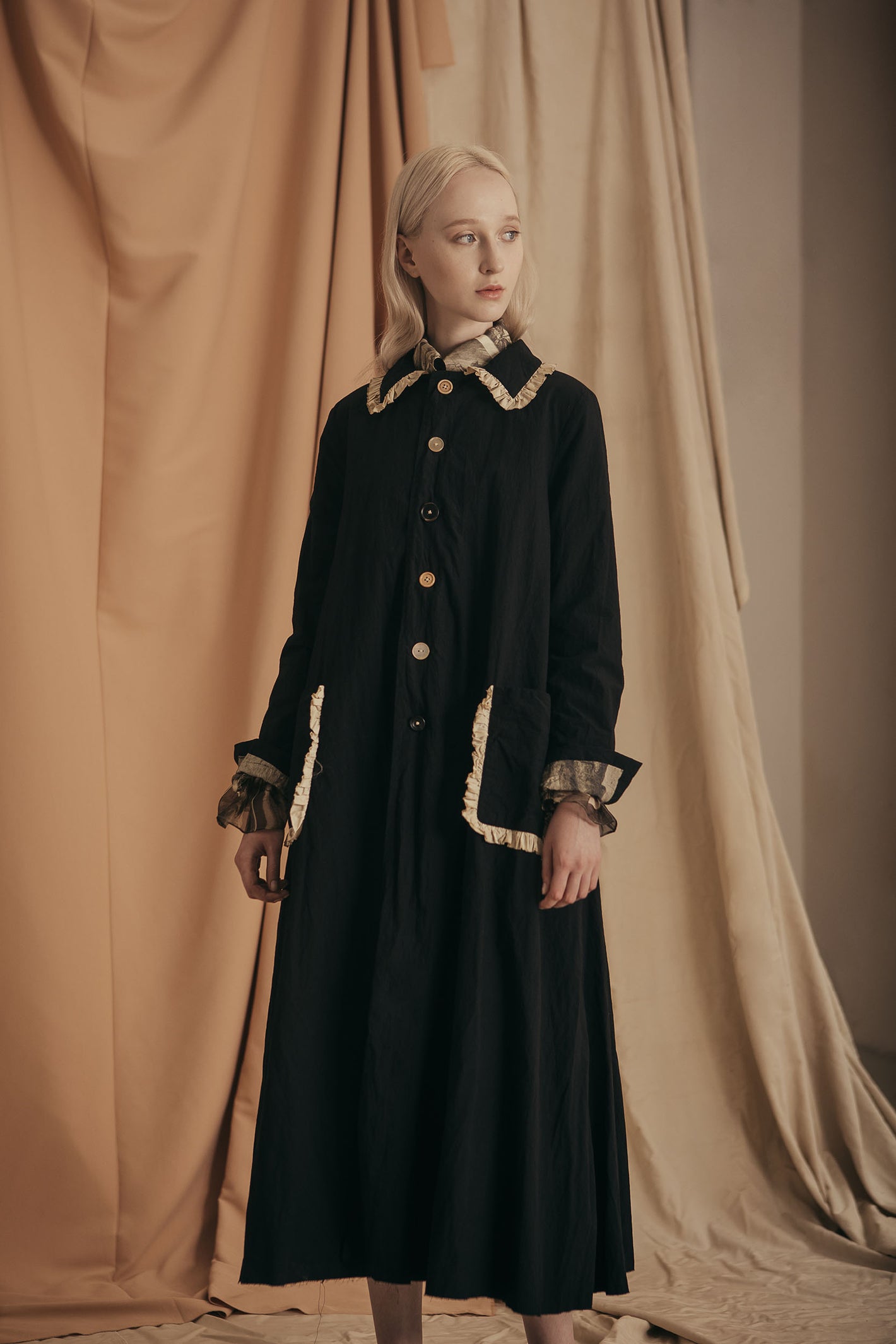 A Tentative Atelier SS20 Lookbook Womens black coat with contrasting ruffle trim