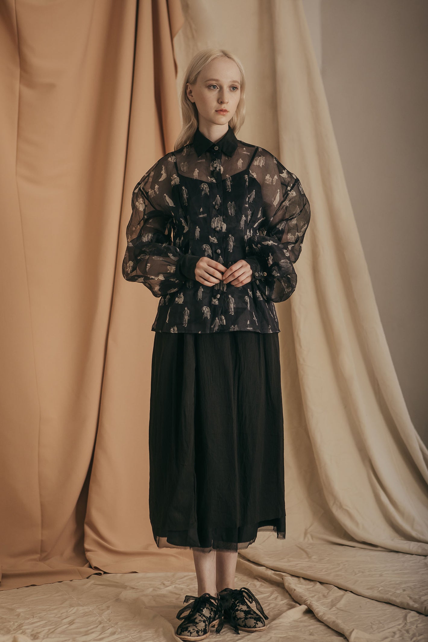 A Tentative Atelier SS20 Lookbook Womens black printed sheer top with oversized sleeves and black skirt