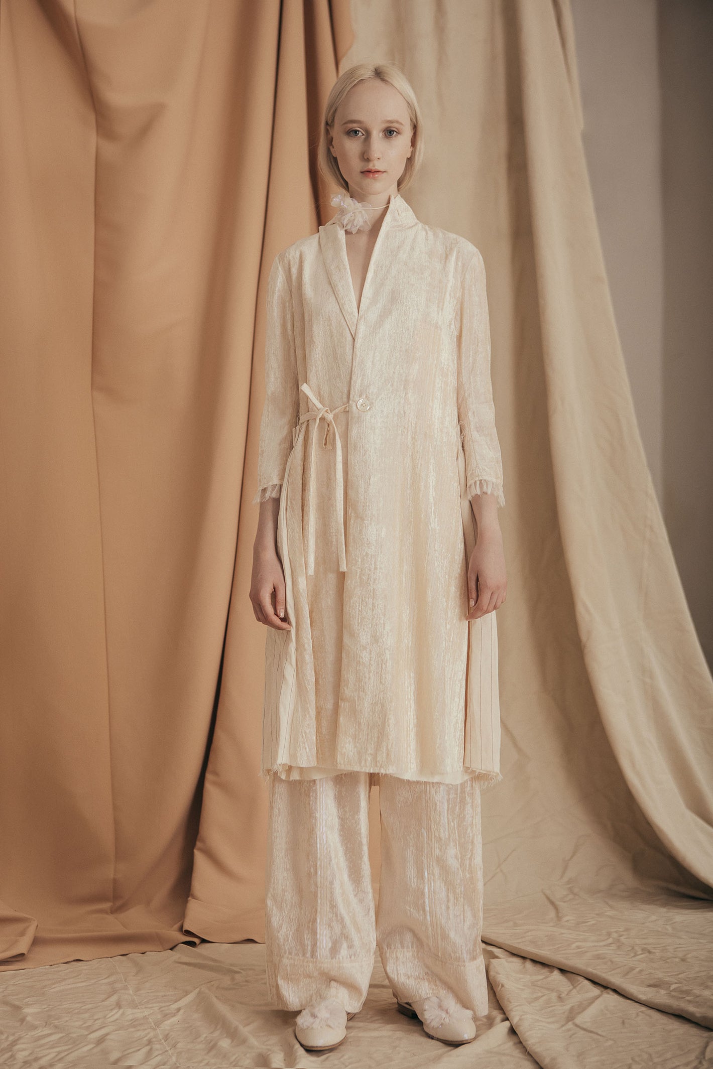A Tentative Atelier SS20 Lookbook Womens white pearlescent side fastening coat and trousers