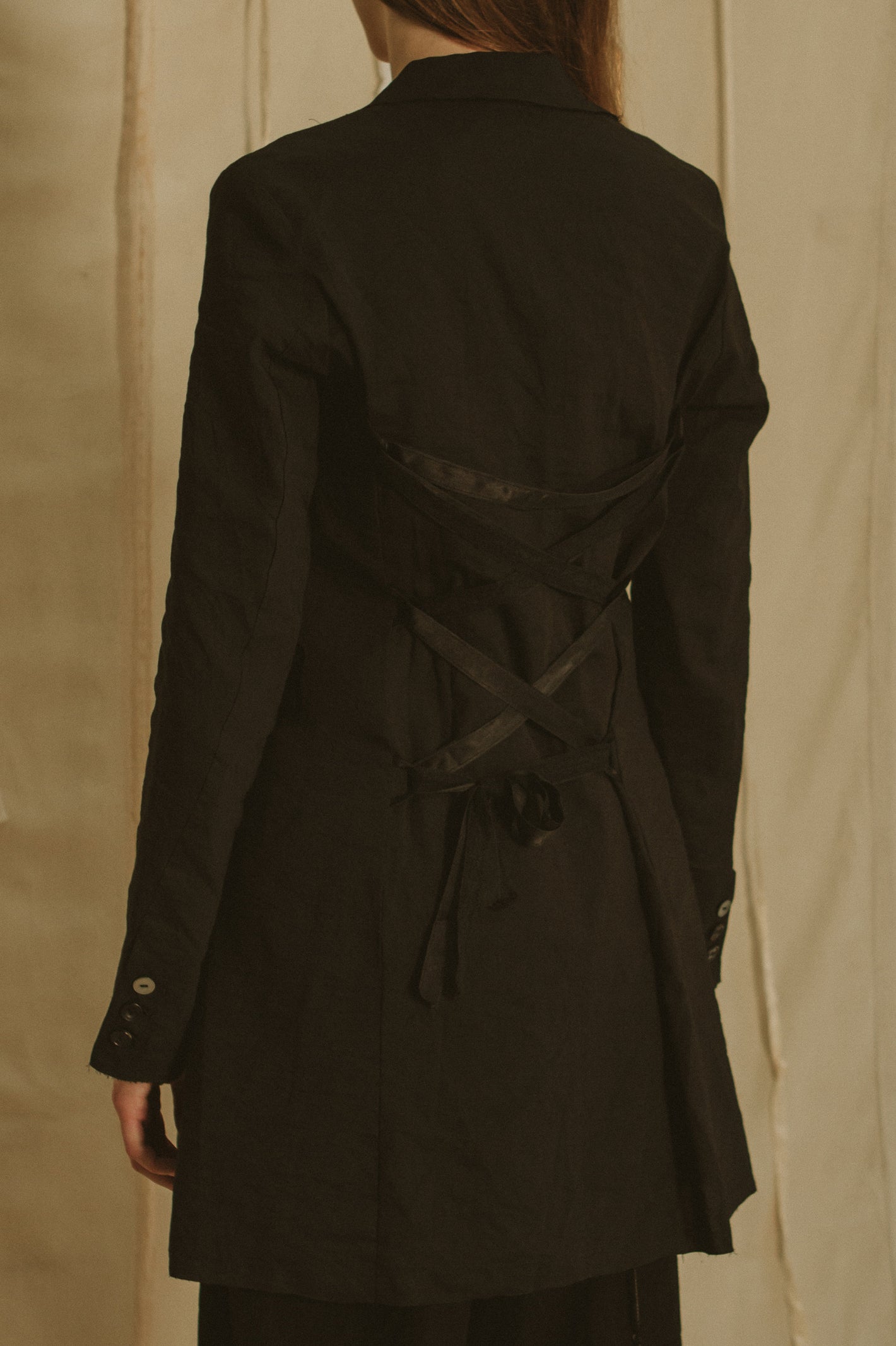 A Tentative Atelier SS19 Lookbook Womens crop of black jacket showing criss-cross ribbon tie back