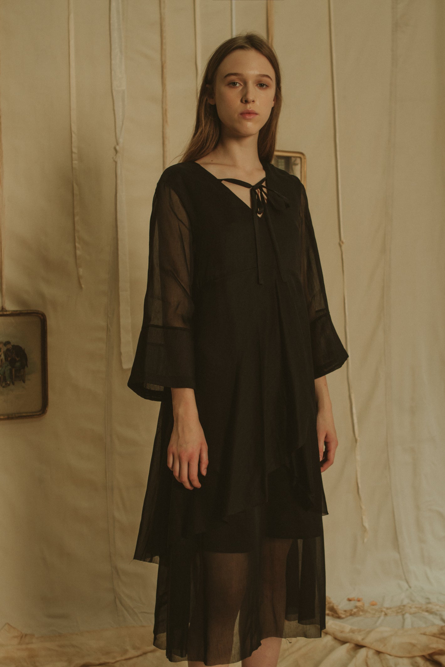 A Tentative Atelier SS19 Lookbook Womens black dress with sheer bell sleeves and v-neck tie